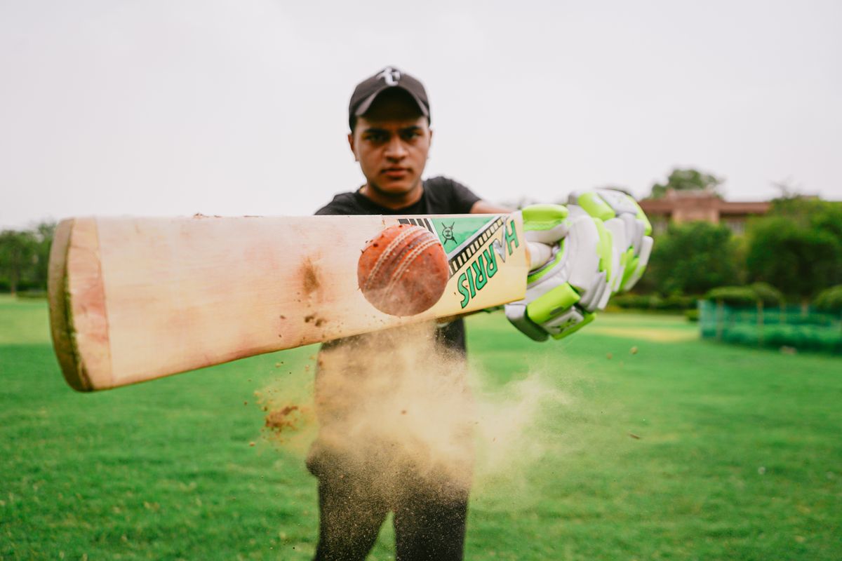 Cricketer driving a ball