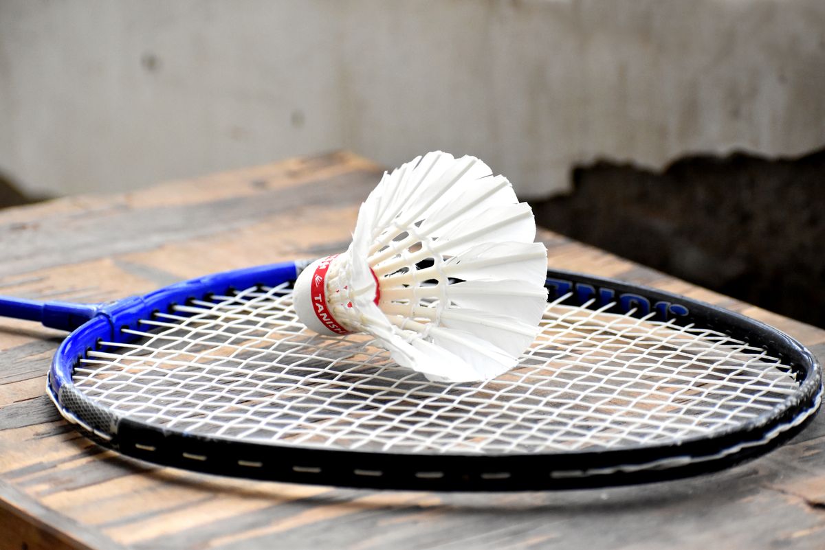 Shuttlecock resting on a badminton racket